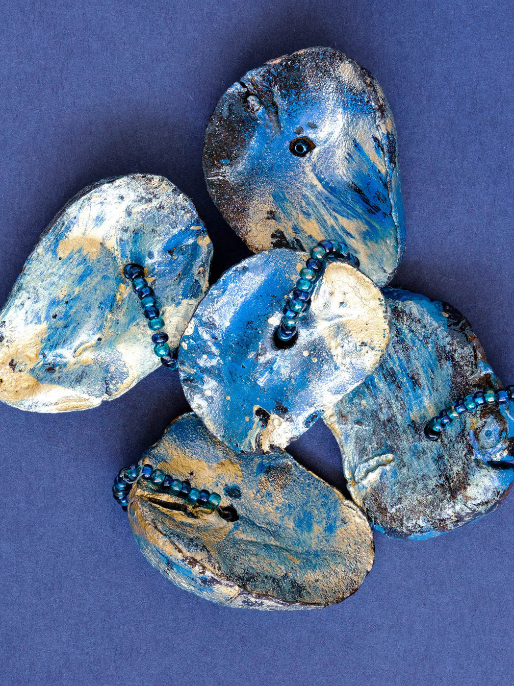 Print of a Cluster of Kolanuts Painted with Blue and Gold Paint