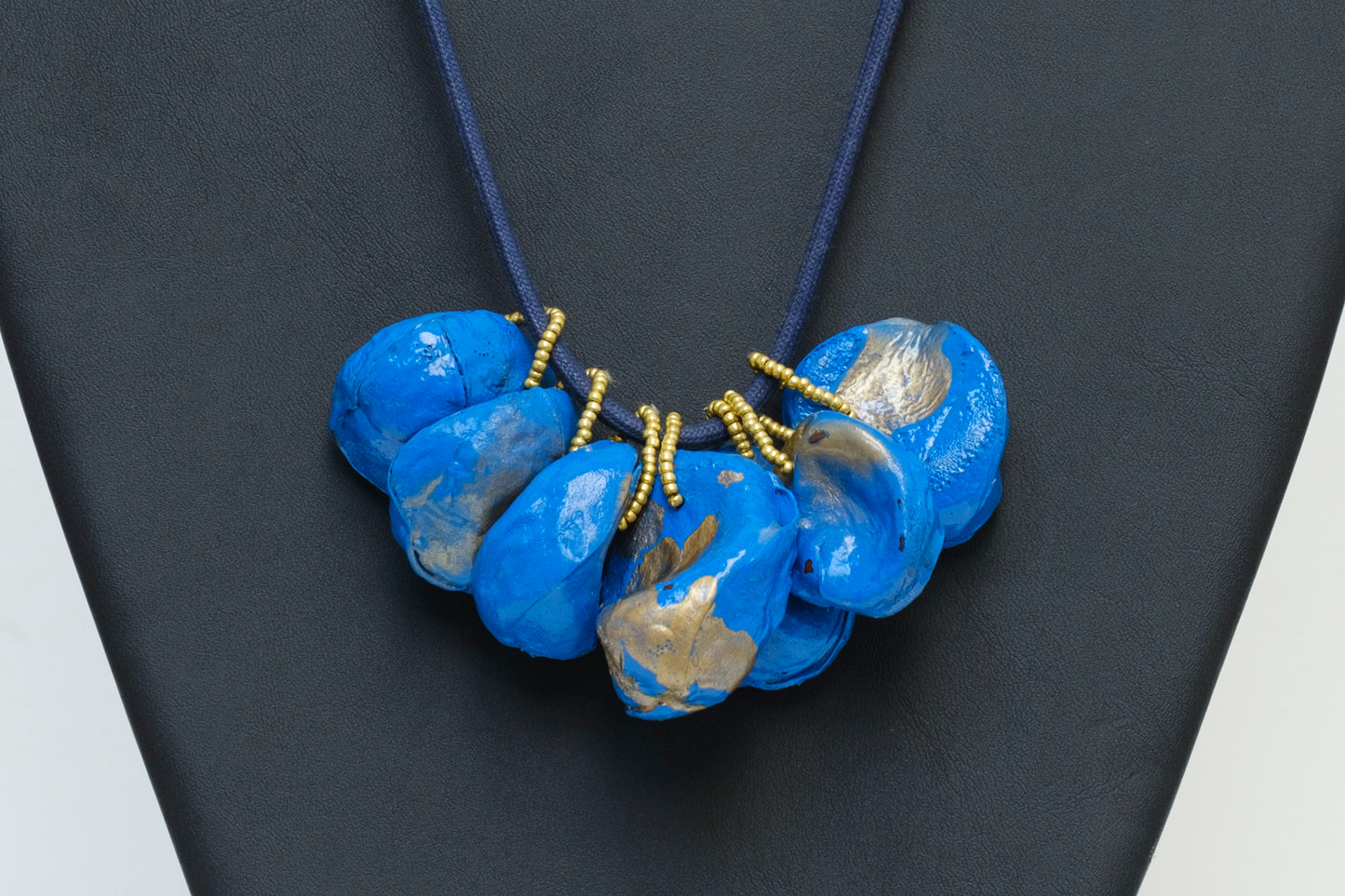 Cluster of Kolanuts Painted with Blue Paint and Gold Leaf with Blue Cord