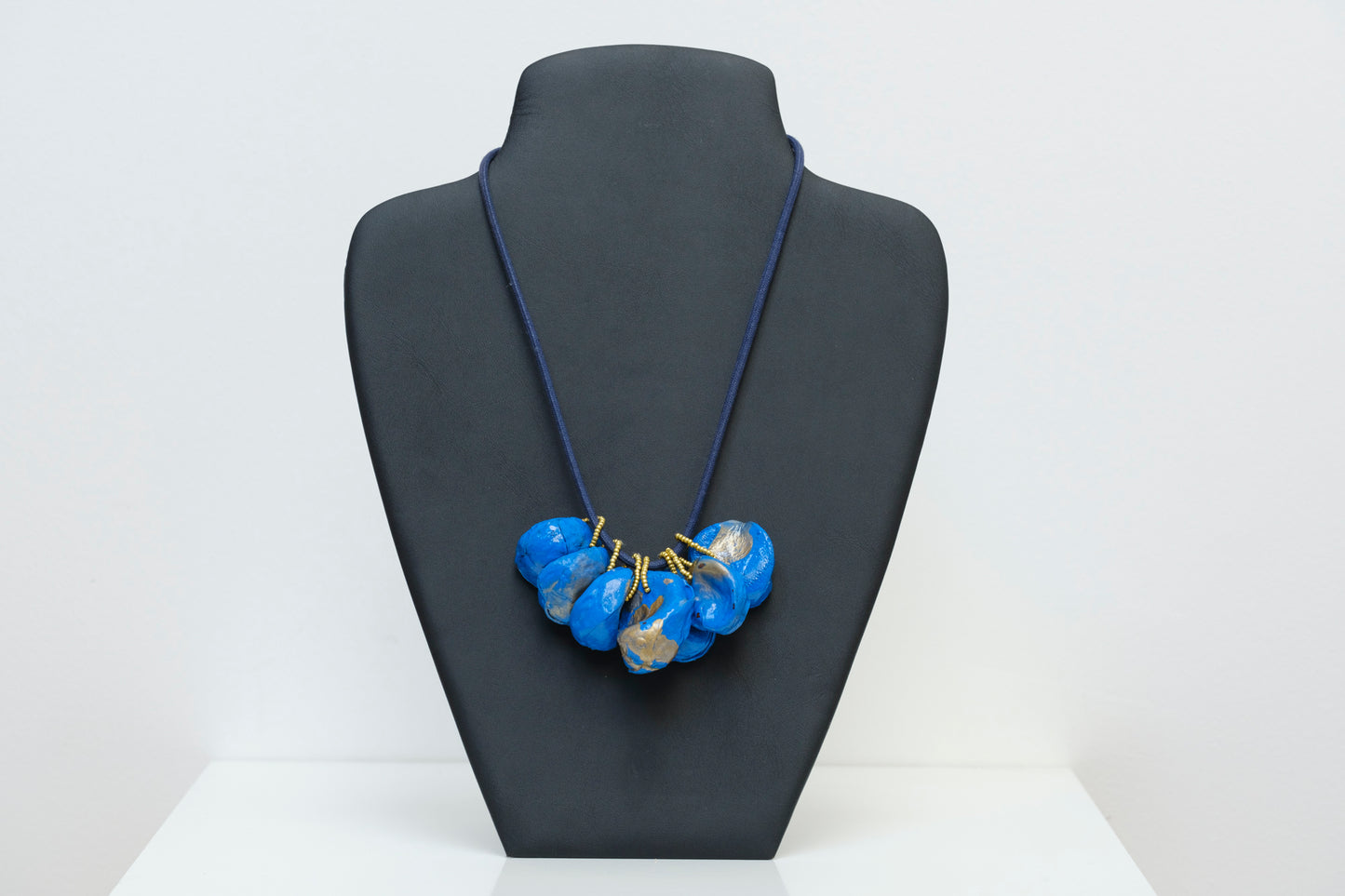 Cluster of Kolanuts Painted with Blue Paint and Gold Leaf with Blue Cord