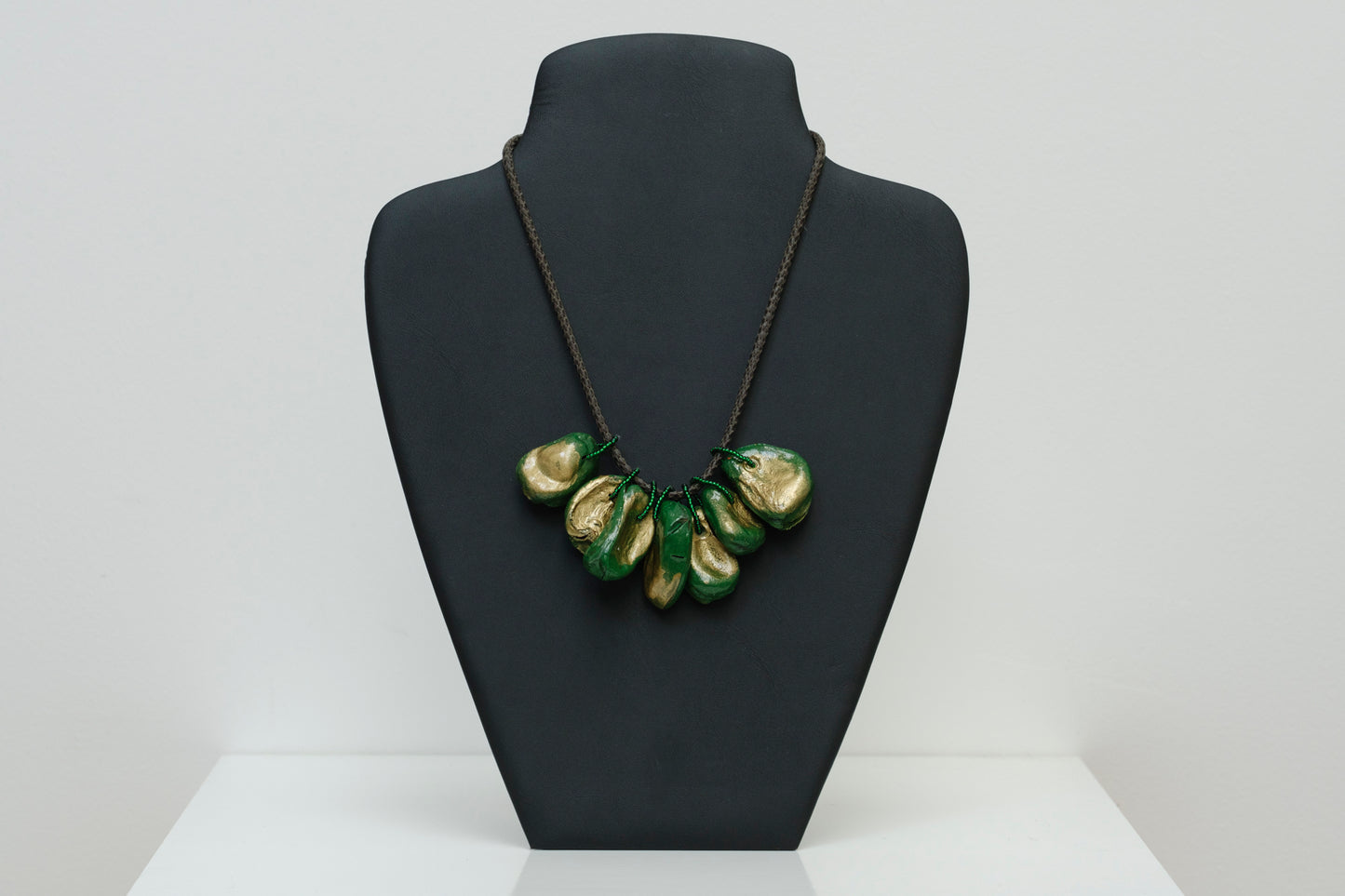 Cluster of Kolanuts Painted with Green and Gold Paint